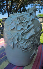 Load image into Gallery viewer, Handcrafted aqua colored vase. Measures 19 x 15. Heavy ceramic with life sized floral design. Slightly damaged on three leafs. $300.00 Booth 2
